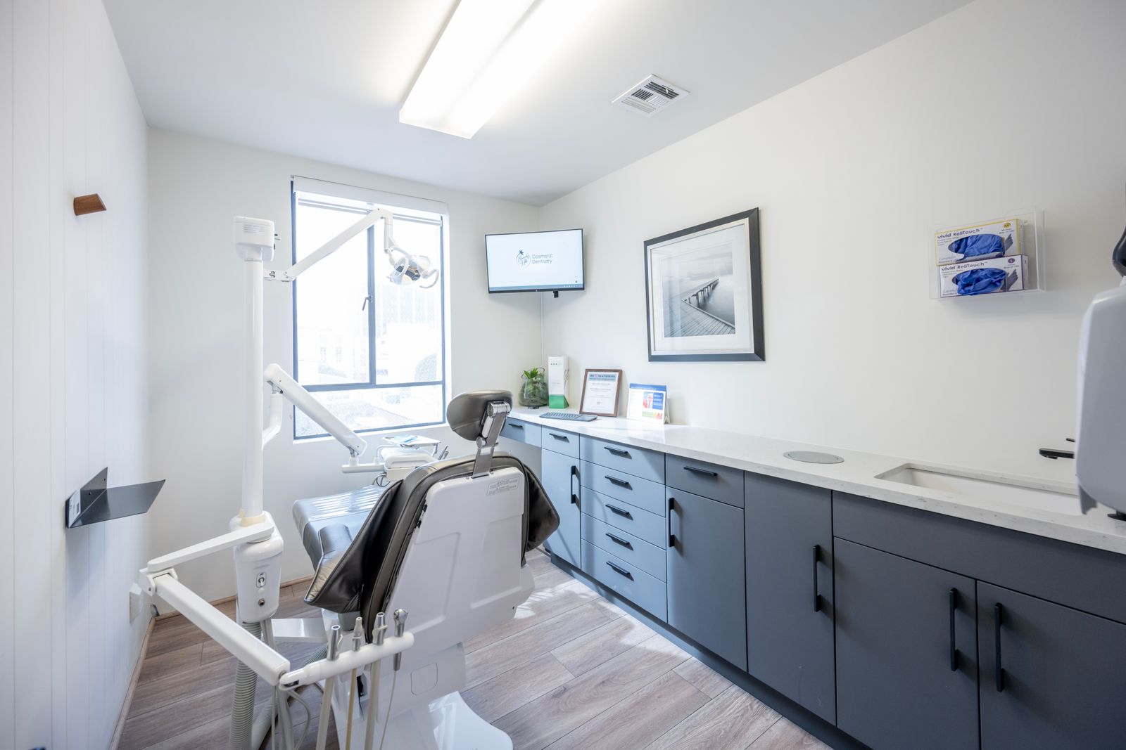 Spacious treatment room with dental chair and equipment